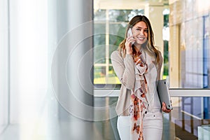 Beautiful business woman using mobile phone outdoors. People communication technology concept.