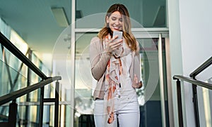 Beautiful business woman using mobile phone outdoors. People communication technology concept.