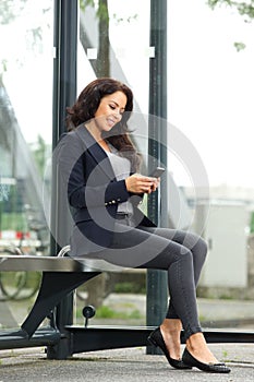 Beautiful business woman waiting at bus stop