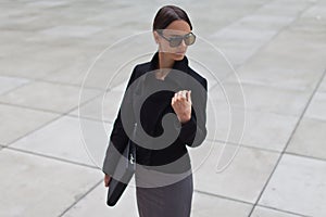 Beautiful business woman is wearing sunglasses
