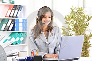 Beautiful business woman working at her desk with