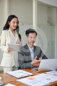 A beautiful businesswoman is briefing work and co-working with a smart male financial analyst