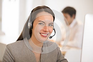 Beautiful Businesswoman in the office on the phone, headset