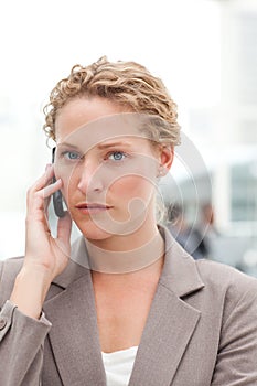 Beautiful businesswoman phoning in her office