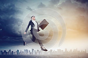 Beautiful businesswoman running on the road