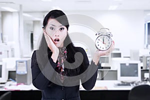 Beautiful businesswoman shock at deadline clock