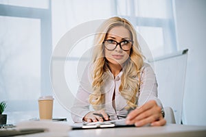 beautiful businesswoman sitting at table