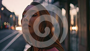 Beautiful businesswoman standing late evening street enjoying cityscape close up