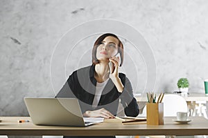 Beautiful businesswoman using smartphone at workplace