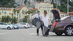 Beautiful businesswoman walking to taxi with chauffer, luxury car services