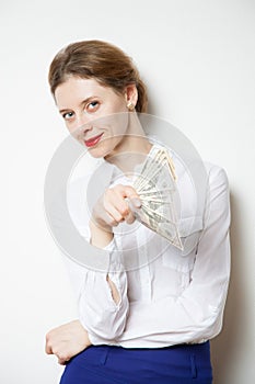 Beautiful businesswoman winking and holding dollars photo