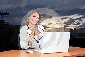 Beautiful Bussiness Woman smiling with her credit in the computer photo