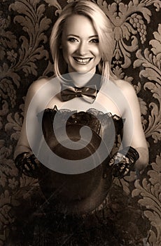 beautiful cabaret woman posing with tophat against retro wallpapers