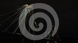 A beautiful cable-stayed bridge, glowing with lights at night.