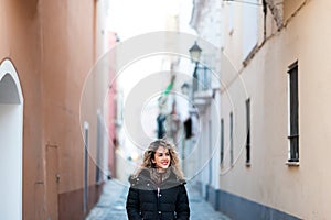 Beautiful cacuasian woman walking on old street. Tourist concept