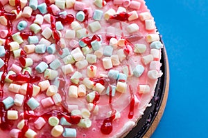 Beautiful Cake with Marshmallows and Raspberry Jam for Party on Blue Background, Close up View