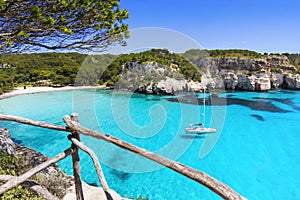 Beautiful Cala Macarella beach, Menorca island, Spain. Sailing boat in a bay. Summer fun, enjoying life, yachting, travel and acti