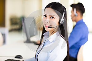 Beautiful call center agent working in office