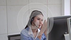 The beautiful call center staff are typing keyboards and talking in a friendly way, providing smiling services, caring for the ser