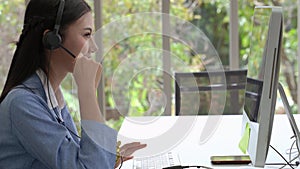 The beautiful call center staff are typing keyboards and talking in a friendly way, providing smiling services, caring for the ser