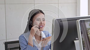 The beautiful call center staff are typing keyboards and talking in a friendly way, providing smiling services, caring for the ser