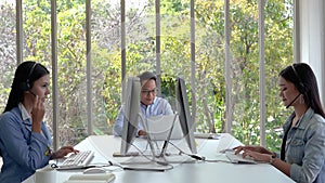 The beautiful call center staff are typing keyboards and talking in a friendly way, providing smiling services, caring for the ser