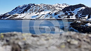 Beautiful calm blue ocean with mighty snowy island mountain range in the background on the Mageroy island, Finnmark, Norway