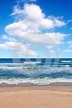 Beautiful, calm and quiet view of the beach, ocean and seashore against a cloudy blue sky on a summer day. Peaceful and