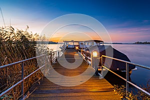 Beautiful calm sea at sunset seen from a wooden dock in Ostprignitz-Ruppin district, Germany