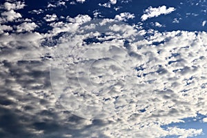 Beautiful calming fluffy white clouds in a deep blue summer sky