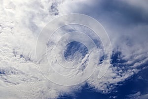 Beautiful calming fluffy white clouds in a deep blue summer sky