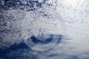 Beautiful calming fluffy white clouds in a deep blue summer sky