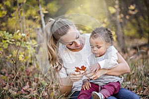 Beautiful candid portrait of a mother playing with her cute bi-racial son photo