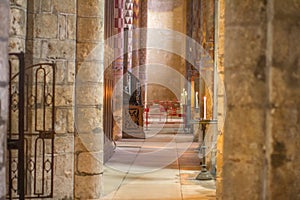 Beautiful candle light in ancient Roman church side-aisle