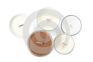 Beautiful candles with wooden wicks on white background, top view