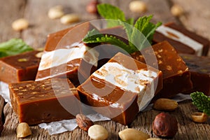 Beautiful candy butterscotch with nuts macro on the table. horizontal