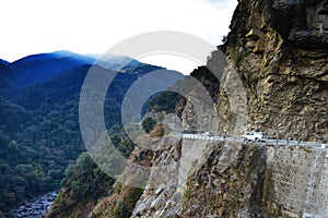 The beautiful canyon and the narrow dangerous mountain road in beautiful Himalayas mountains with steep slopes in Bhutan