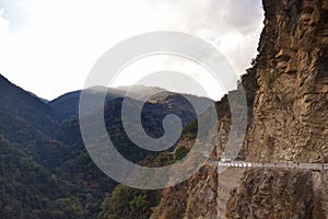 The beautiful canyon and the narrow dangerous mountain road in beautiful Himalayas mountains with steep slopes in Bhutan