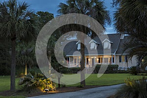 Beautiful cape cod house lit up at twilight