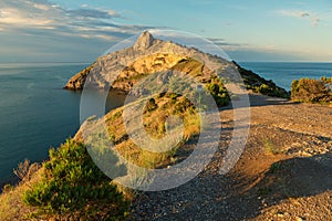 Beautiful Cape Kapchik in the Black Sea illuminated rising sun. Crimea.