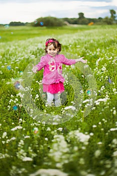 Beautiful carefree girl playing outdoors in field