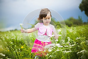 Beautiful carefree girl playing outdoors in field