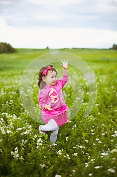 Beautiful carefree girl playing outdoors in field