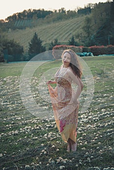 Beautiful carefree woman in fields being happy