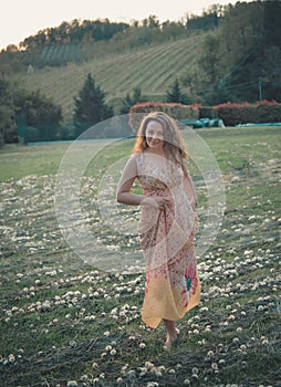 Beautiful carefree woman in fields being happy