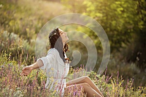 Beautiful carefree woman in fields being happy outdoors