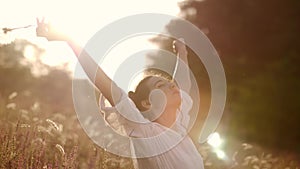 Beautiful carefree woman in fields being happy outdoors