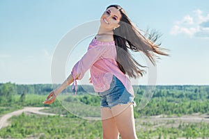 Beautiful carefree woman with long healthy hair outdoors