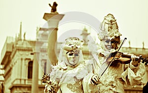 The beautiful carnival costumes with the violinist and his partner