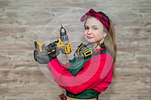 Beautiful carpent worker posing with drill machine